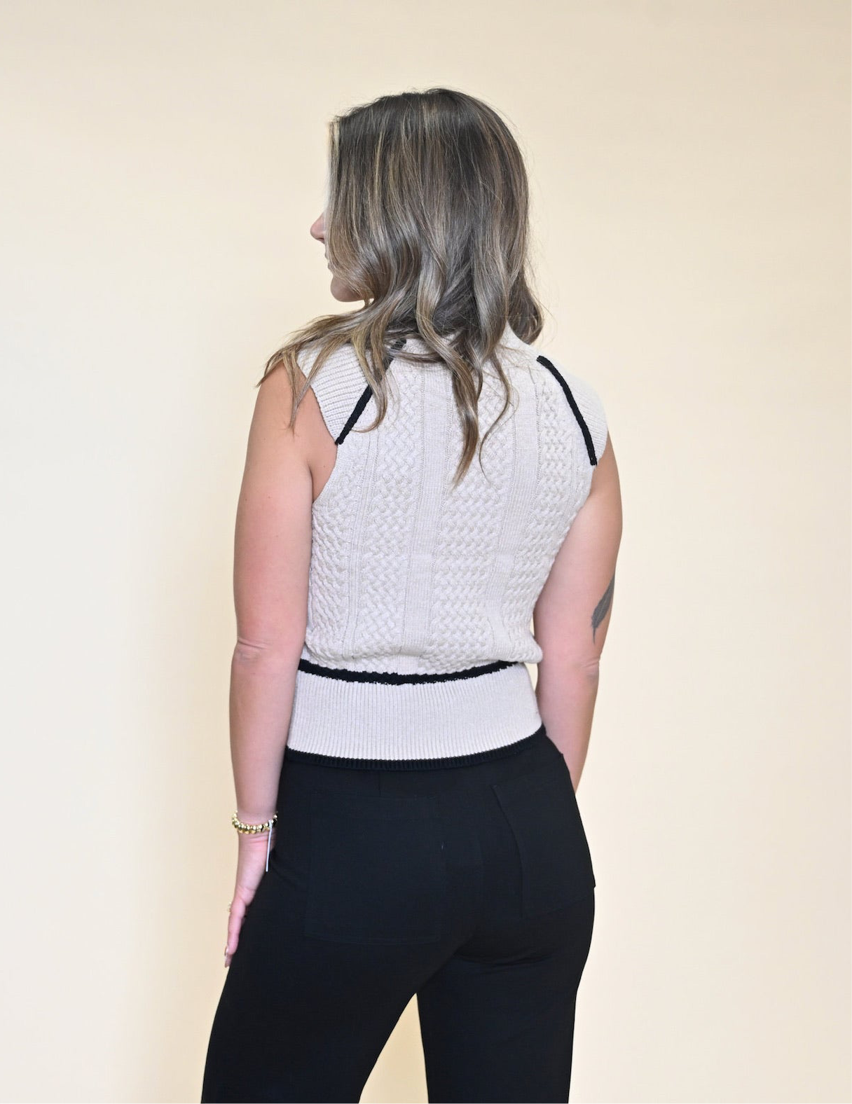 Chic Dèluc Sweater Vest with turtleneck design and subtle stitched detailing for a modern, elevated layering piece.