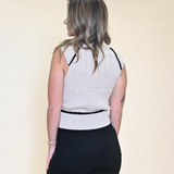 Chic Dèluc Sweater Vest with turtleneck design and subtle stitched detailing for a modern, elevated layering piece.