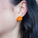 Orange pumpkin-shaped studs by Spiffy and Splendid — lightweight design adds a playful autumn touch to any outfit.