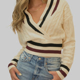 Steve Madden Addison Sweater — classic cropped knit with preppy varsity-inspired stripes at the V-neck, waist, and cuffs for a polished yet playful fall look.