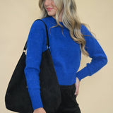 Pistola Sara Crewneck Sweater in Azure Blue styled with black handbag & black suede shorts — soft knit women’s sweater from Shear Boutique