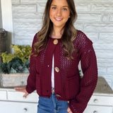 Bold red Dear John Sweater with chunky knit texture and three gleaming gold buttons — warm, stylish, and eye-catching.