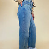 side view of model wearing kyra high rise bowed ankle women's trendy jeans. Pistola - shear boutique jeans fall