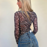 back view of Mystree lettuce hem black floral mesh print top