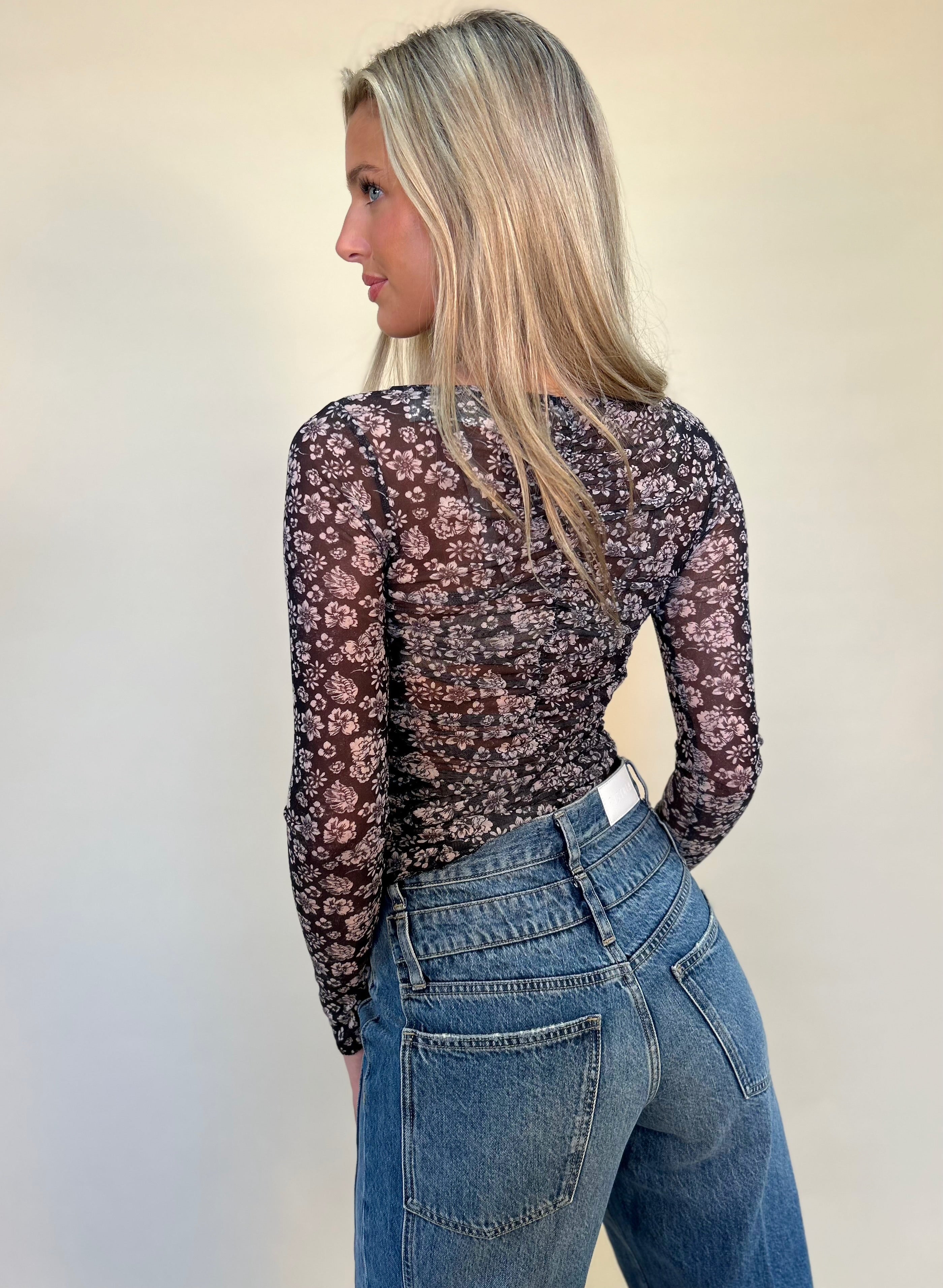 back view of Mystree lettuce hem black floral mesh print top