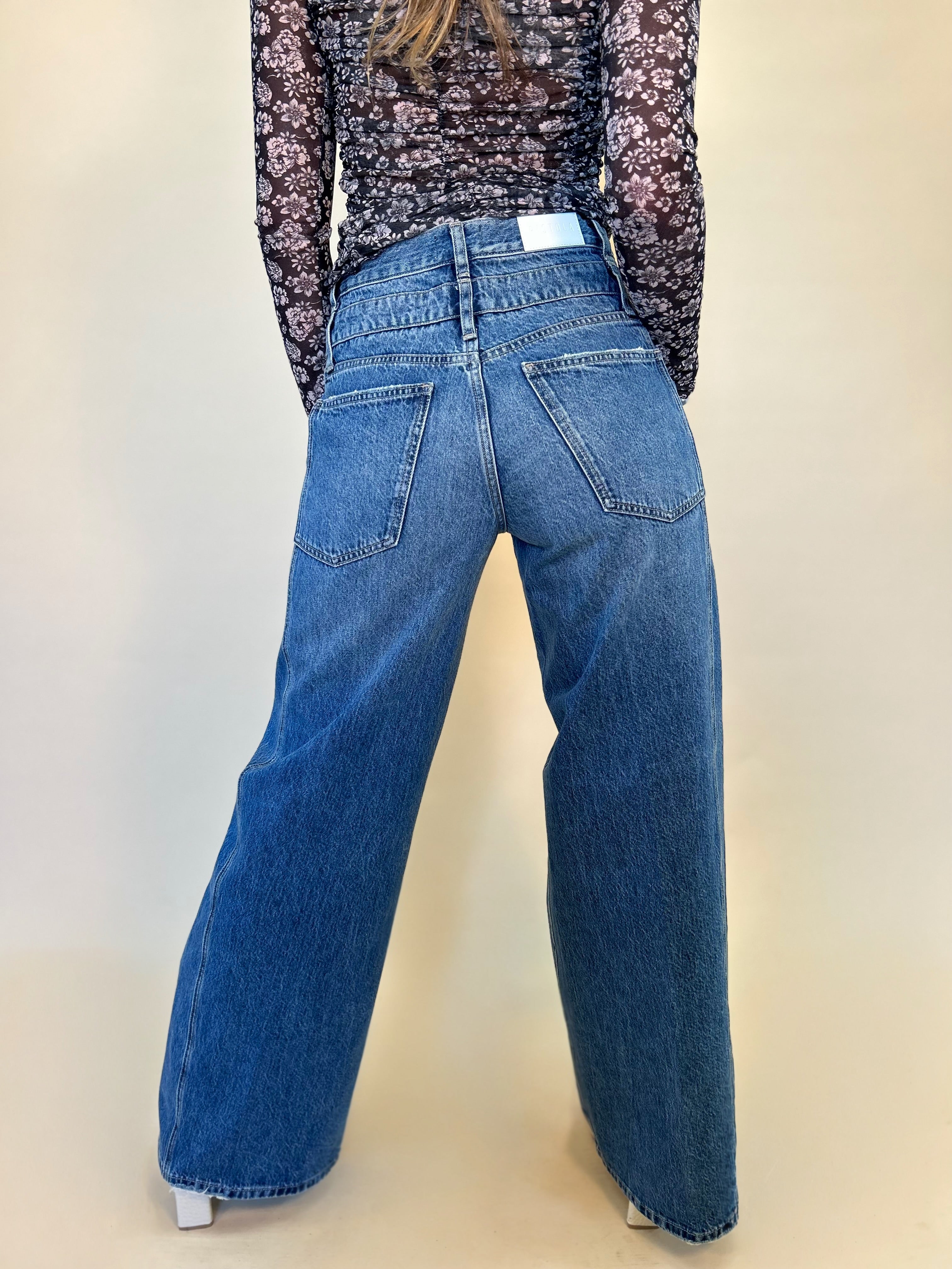 close up back view of caleb high rise relaxed stacked waist jeans from pistola on model - shear boutique