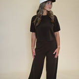 Model wearing Shear Boutique Kori Wide Leg Knit Pants with matching Kori Elbow Sleeve Sweater Top in Dark Espresso, women’s lounge set front view.