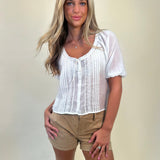 Lana Top in white with sheer lace, short puff sleeves, and tie scoop neck, styled with Hampton suede cuffed shorts – women’s delicate blouse outfit – Shear Boutique