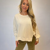 Dear John Trenton Long Sleeve Shirt — soft white fabric with a classic round neckline, puff sleeves, and side slits for a cozy yet elevated look.