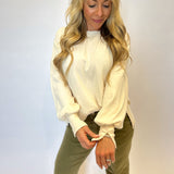Women’s Dear John Trenton Top in white featuring dramatic puff sleeves, wide slit cuffs, and a longer back hem for relaxed sophistication.