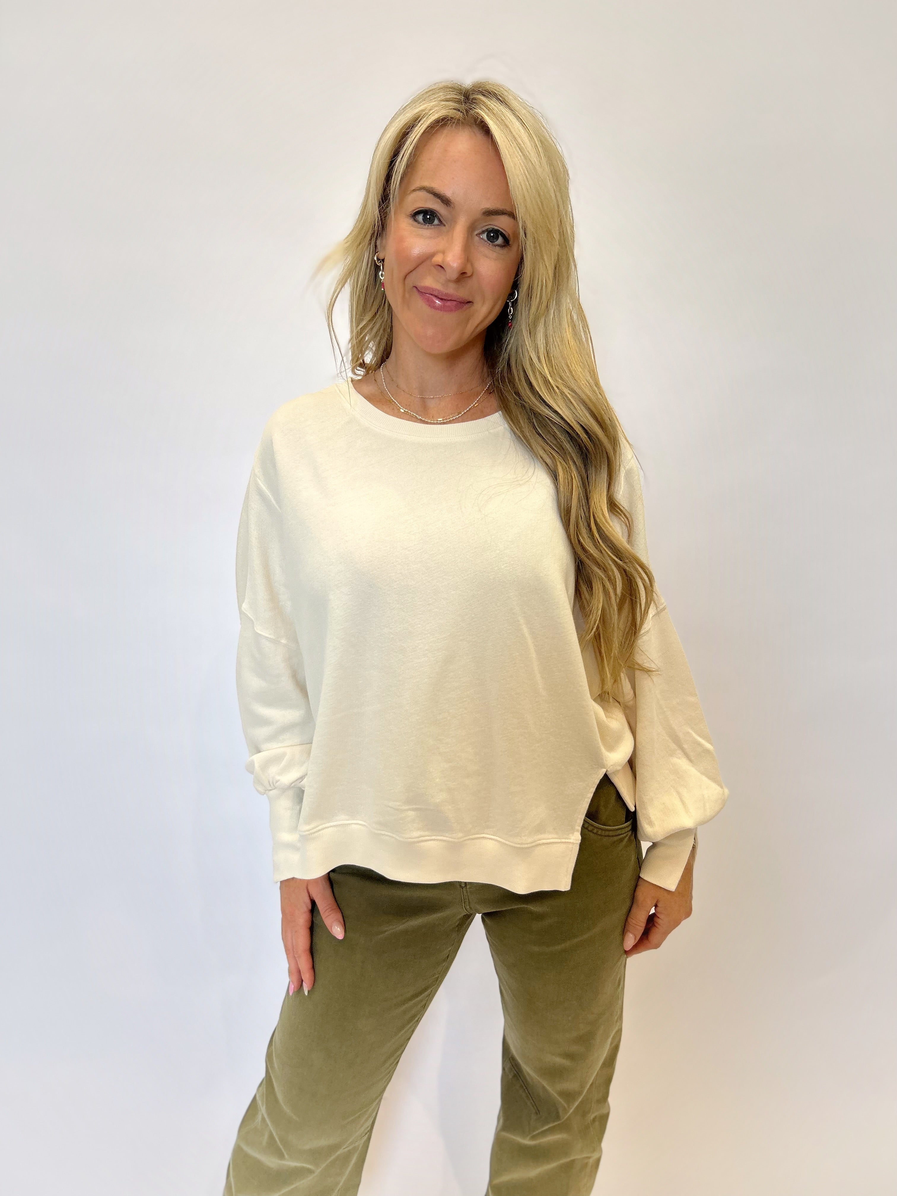 Chic and comfortable Dear John Trenton Long Sleeve Shirt — white knit with puff sleeves, wide cuffs, and a flattering longline silhouette.