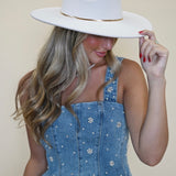 Fiorella Top from Steve Madden: denim peplum tank top/ corset top with pearl floral embellishments front view worn with white cowboy hat. Shear boutique fall collection women's tops