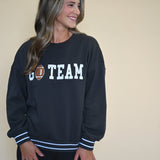 Oversized black Z Supply crew neck sweatshirt with white football-style stripes on the sleeves, designed for a comfy, relaxed fit.
