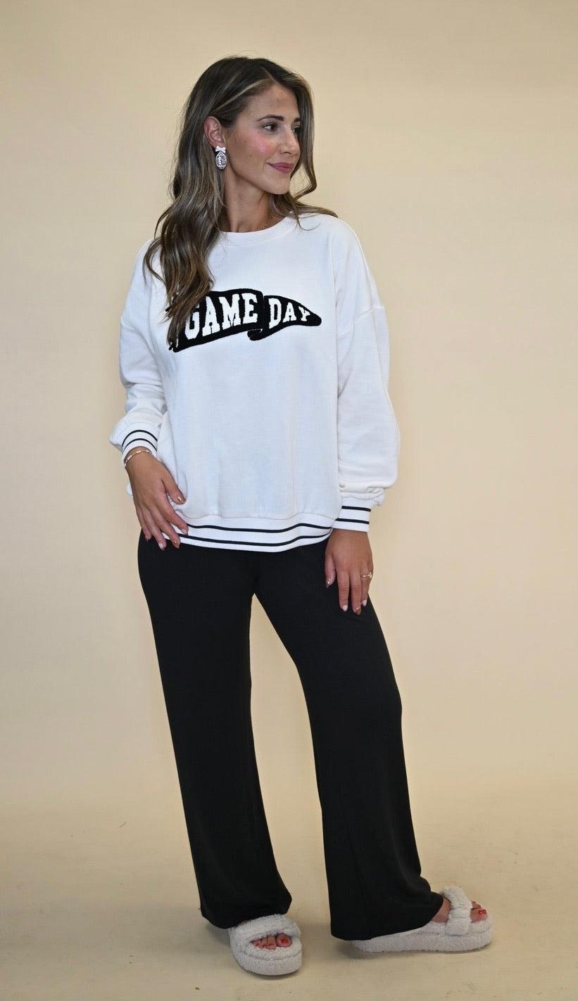 Women’s Z Supply Game Day Sweatshirt featuring a relaxed oversized fit, white body with black striped sleeves, and a heavy soft wash finish.
