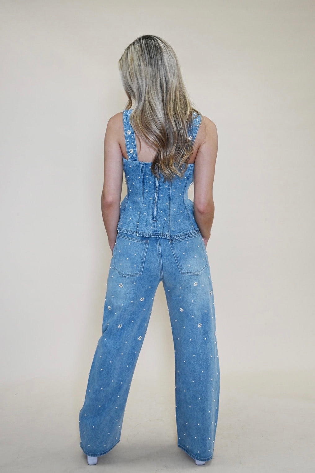 Back view of model in Steve Madden Fiorella Embellished Denim Top and Fianna Embellished Barrel Jeans, showing fit and detailing