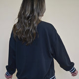 Comfy and casual black crew neck sweatshirt from Z Supply with sporty white stripes on the arms, perfect for game day or lounging.
