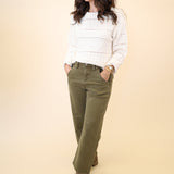 Green barrel leg denim cargos by Dear John styled with the Cento Cable Knit Sweater — casual and chic