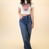 Soft white baby tee with vintage heart tattoo graphic reading “Love” by Girl Dangerous