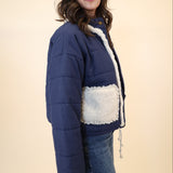 Navy button-down quilted jacket by Miou Muse featuring soft neck and cozy sherpa pockets