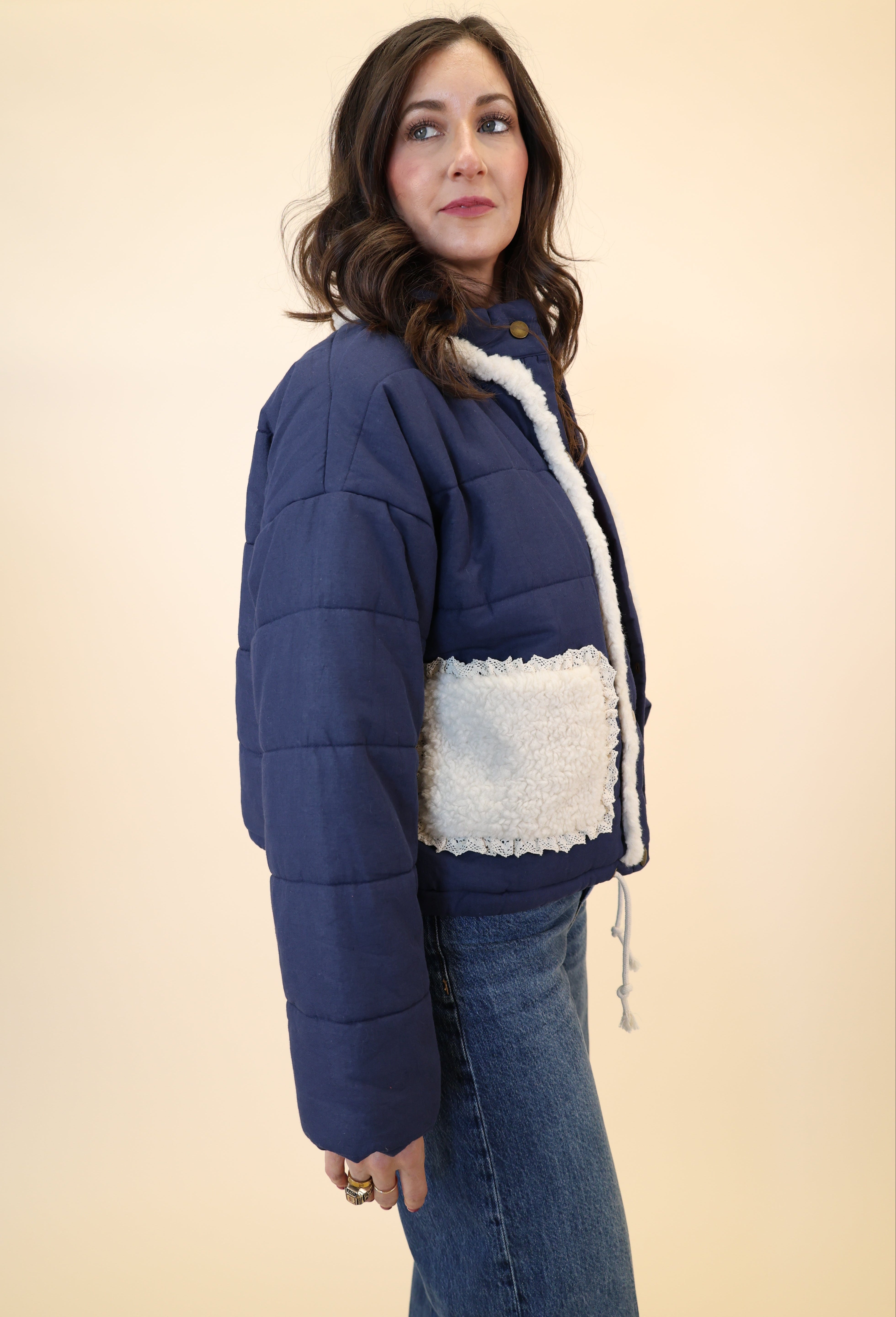 Navy button-down quilted jacket by Miou Muse featuring soft neck and cozy sherpa pockets