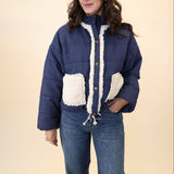 Navy quilted jacket from Miou Muse with plush white sherpa pockets and soft collar detail