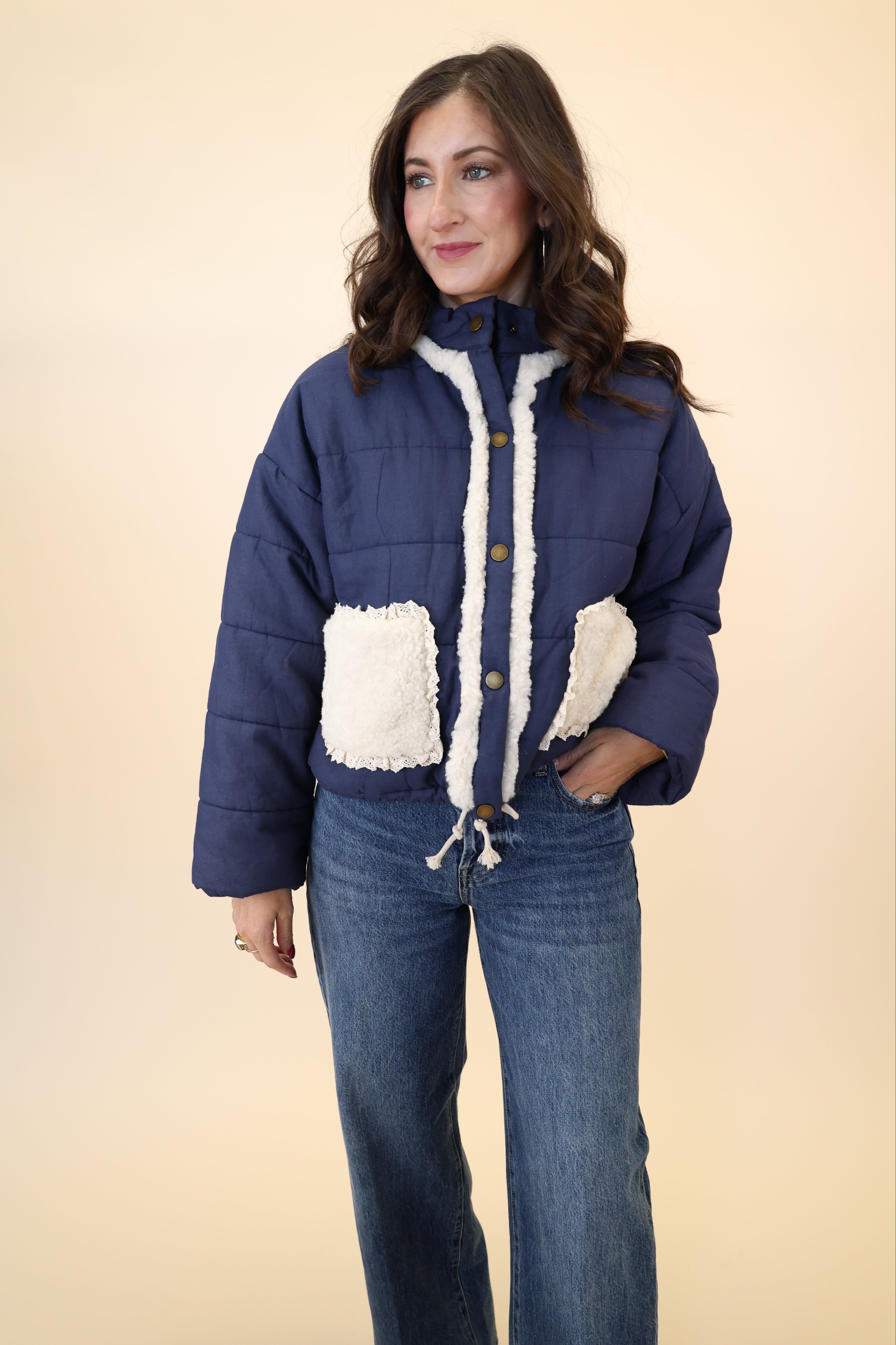 Navy quilted jacket from Miou Muse with plush white sherpa pockets and soft collar detail
