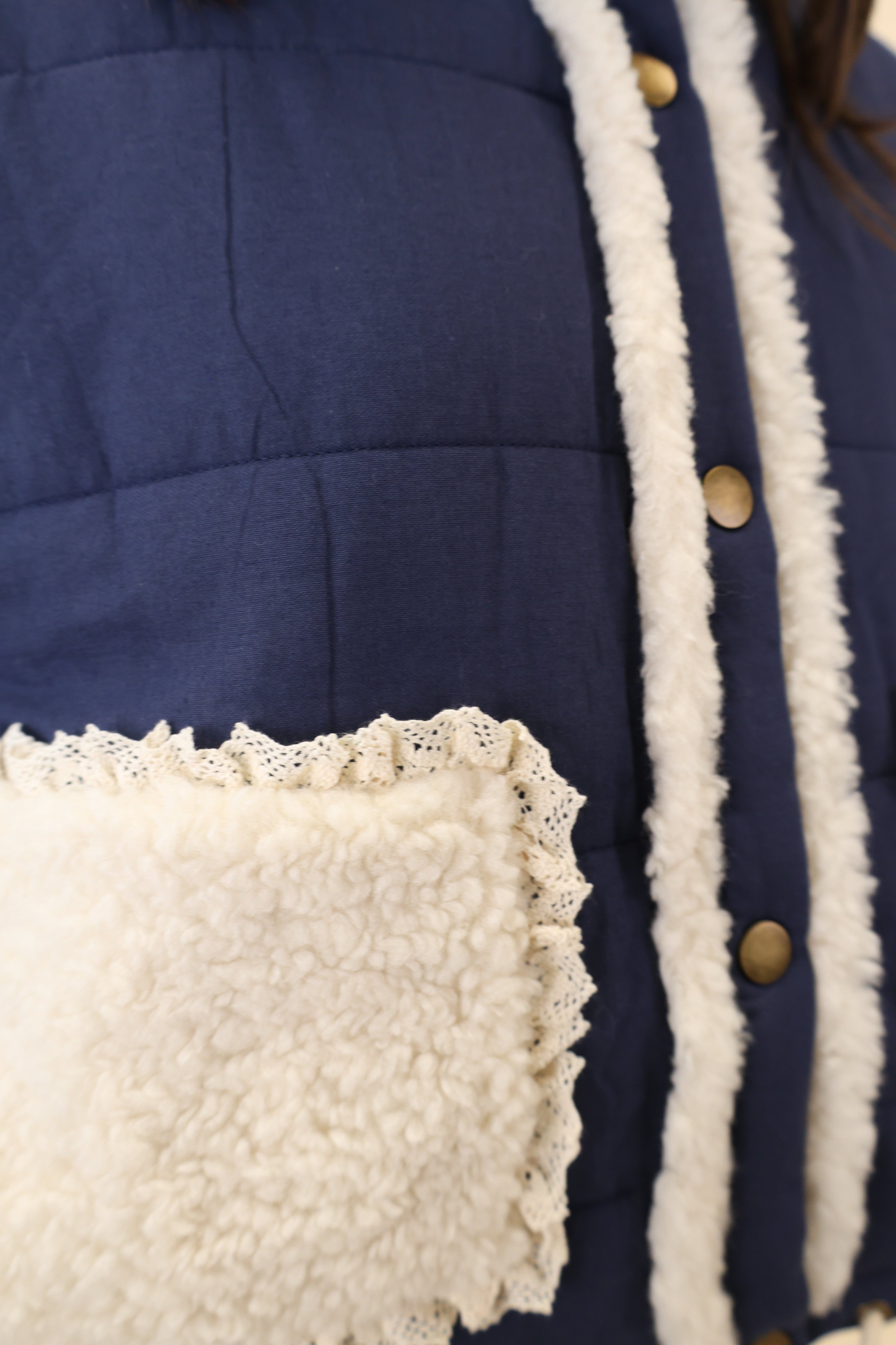 Cozy navy Miou Muse quilted jacket — white sherpa pockets, soft neckline, and drawstring hem