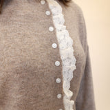 Beige button-down cardigan by Miou Muse featuring romantic white lace detailing