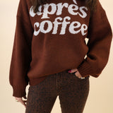 Cozy brown knit sweatshirt by Girl Dangerous featuring white “Après Coffee” graphic