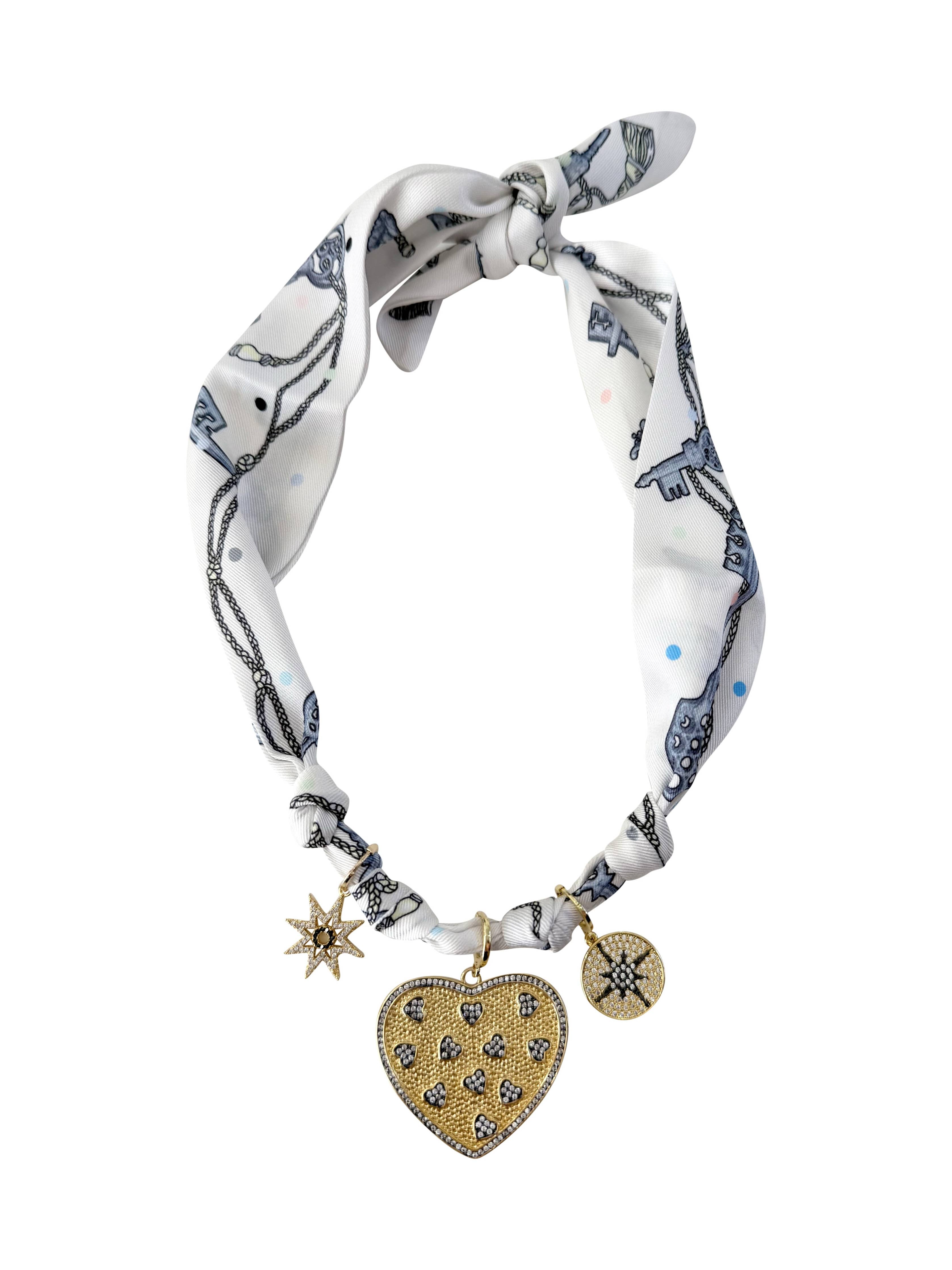 Gemelli Candice Multi Charm Scarf necklace featuring an adjustable satin scarf with interchangeable 18k gold-plated  charms. 