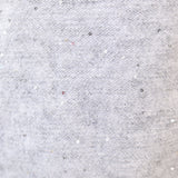 Close-up of Deluc Catalpa Sweater showing silver shimmer detail and soft grey knit texture.