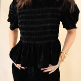 Close-up of Deluc black velvet top highlighting luxe texture and wide short-sleeve design.