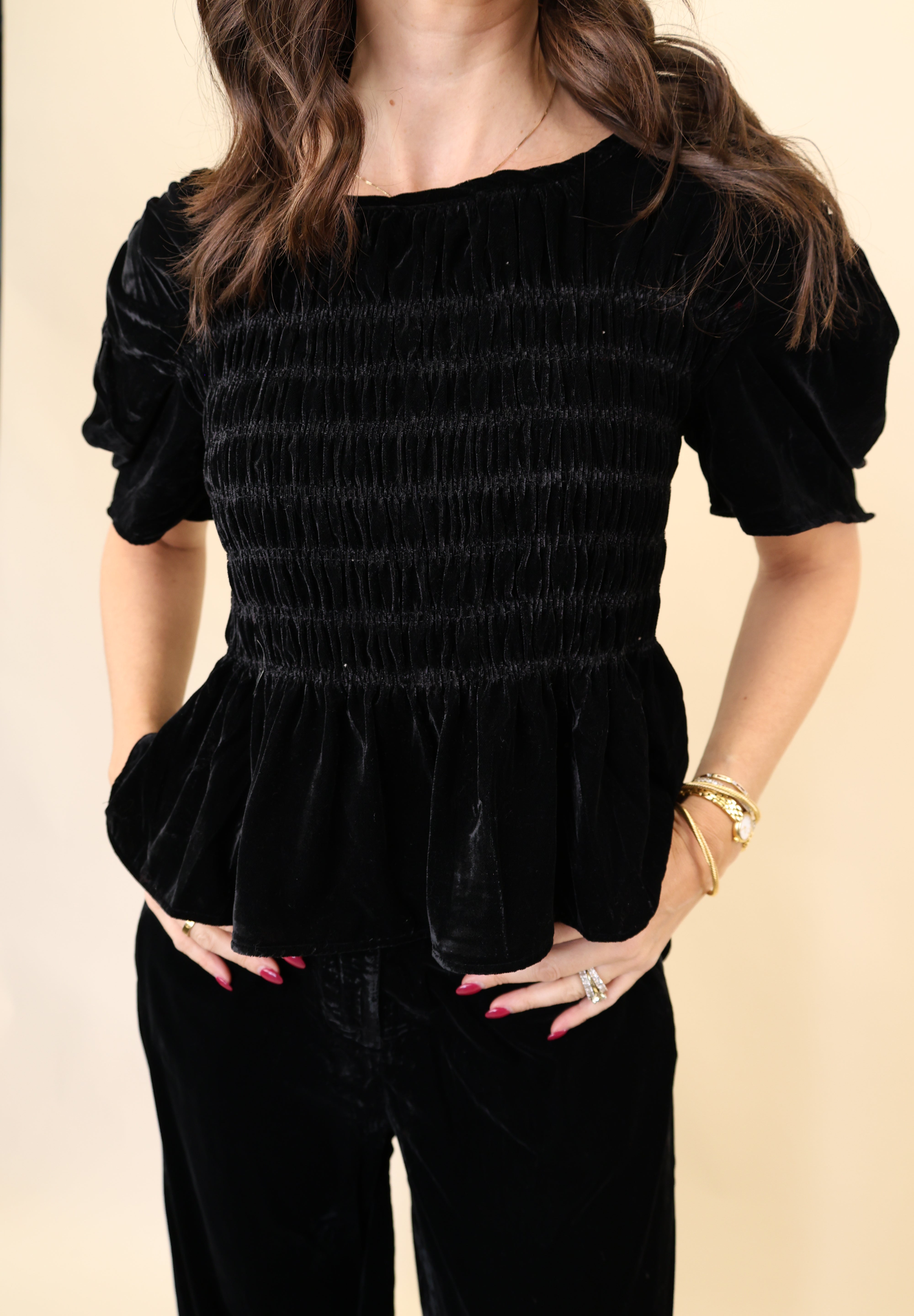 Close-up of Deluc black velvet top highlighting luxe texture and wide short-sleeve design.