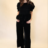 Black velvet wide leg pants from Deluc featuring soft drape and relaxed fit.