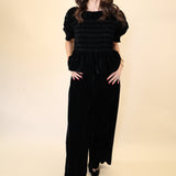 Front view of Deluc Daisy Pants showcasing plush black velvet fabric and flowy wide leg design.