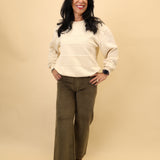 Close-up of Pistola Penny wide-leg cropped denim pants in olive green with a flattering high-rise fit.