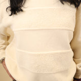 Cream crewneck sweatshirt featuring textured horizontal contrast stripes and a soft, cozy feel.