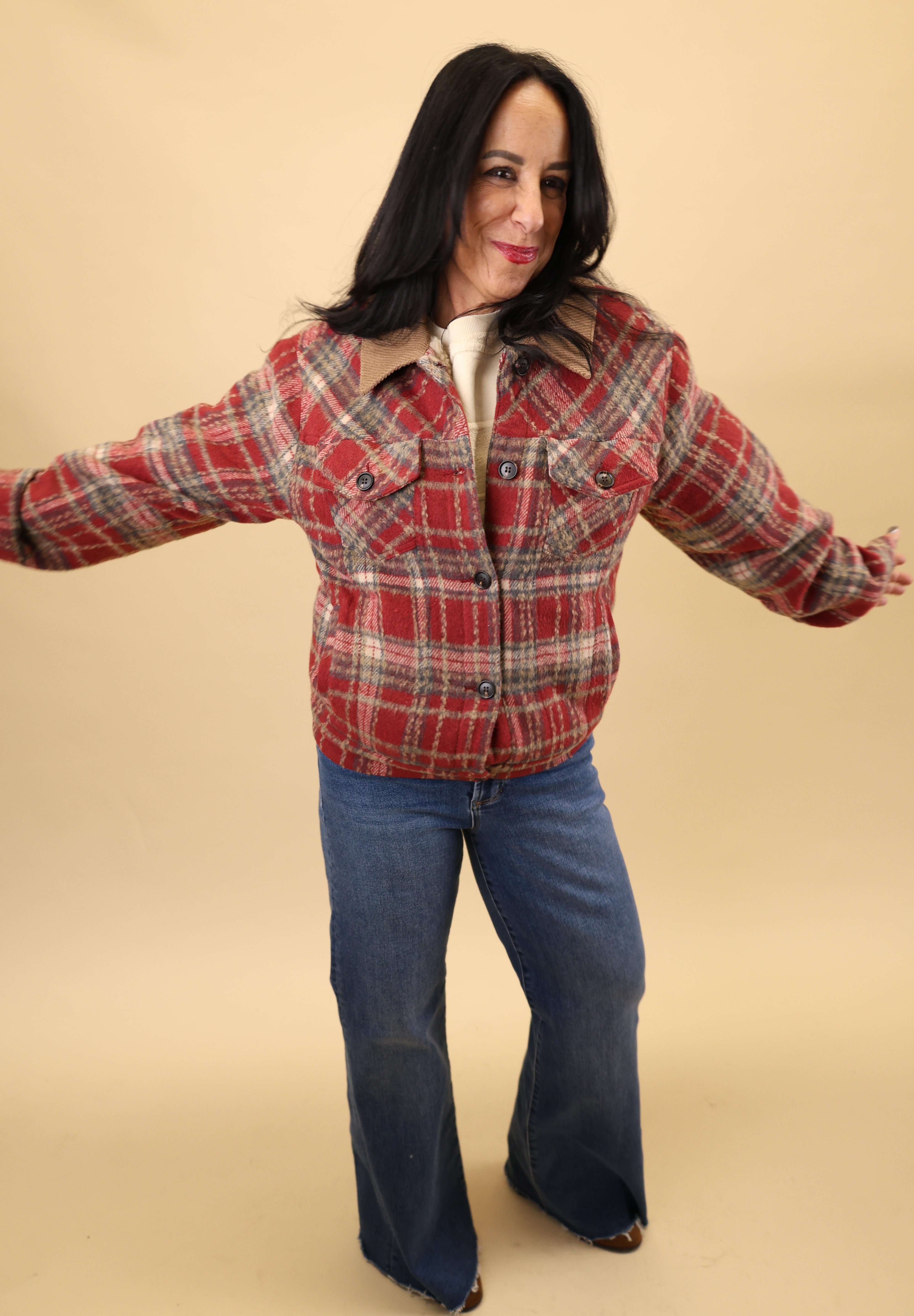 Sherpa-lined red plaid jacket by Dear John with long sleeves, button-front design, front welt pockets, and a fitted cuffed waistband.