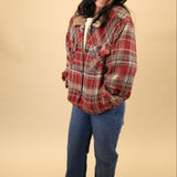 Cozy red plaid jacket with soft sherpa lining, button-front style, long sleeves, welt pockets, and finished cuffs and waistband.