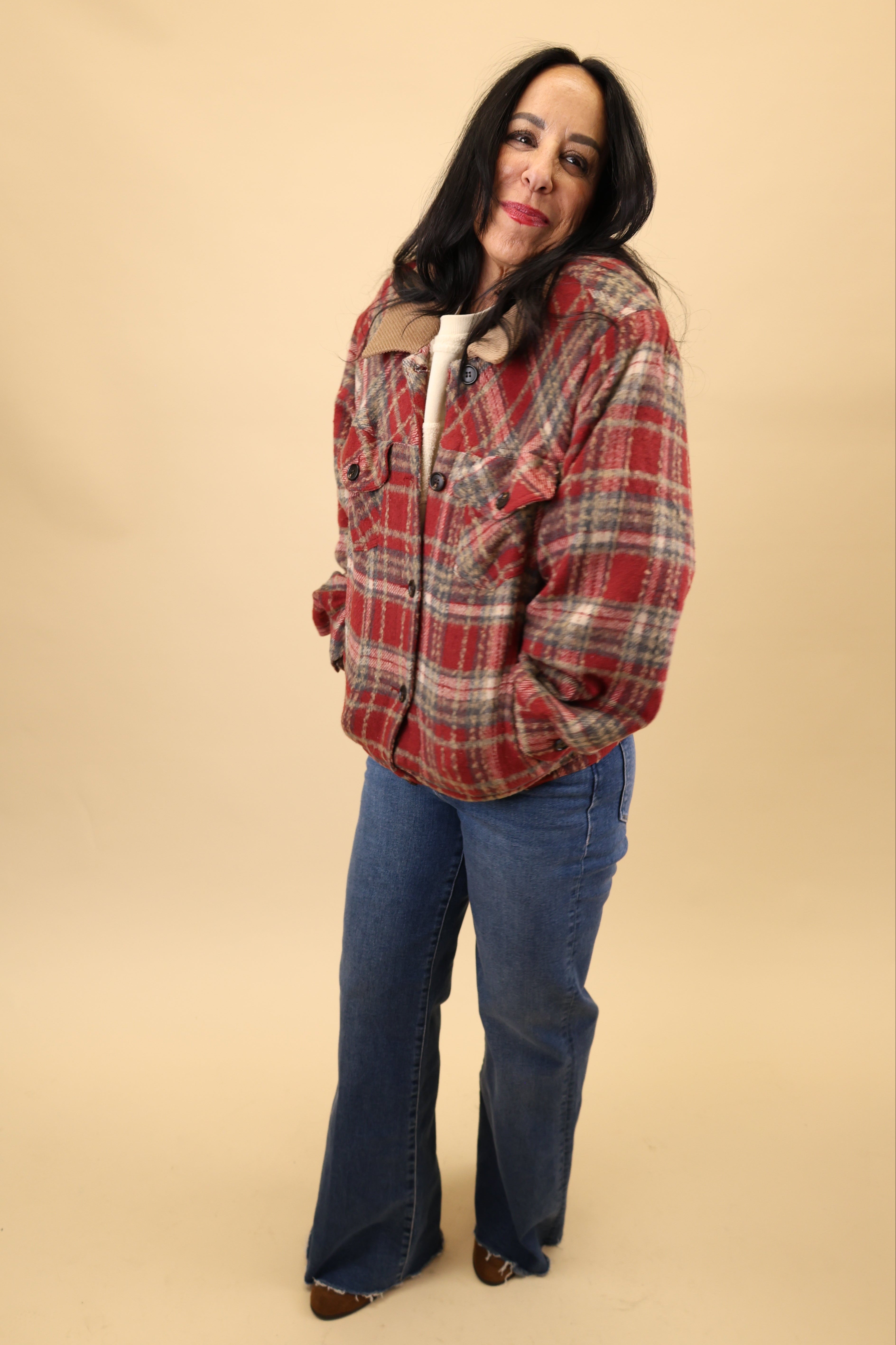 Cozy red plaid jacket with soft sherpa lining, button-front style, long sleeves, welt pockets, and finished cuffs and waistband.