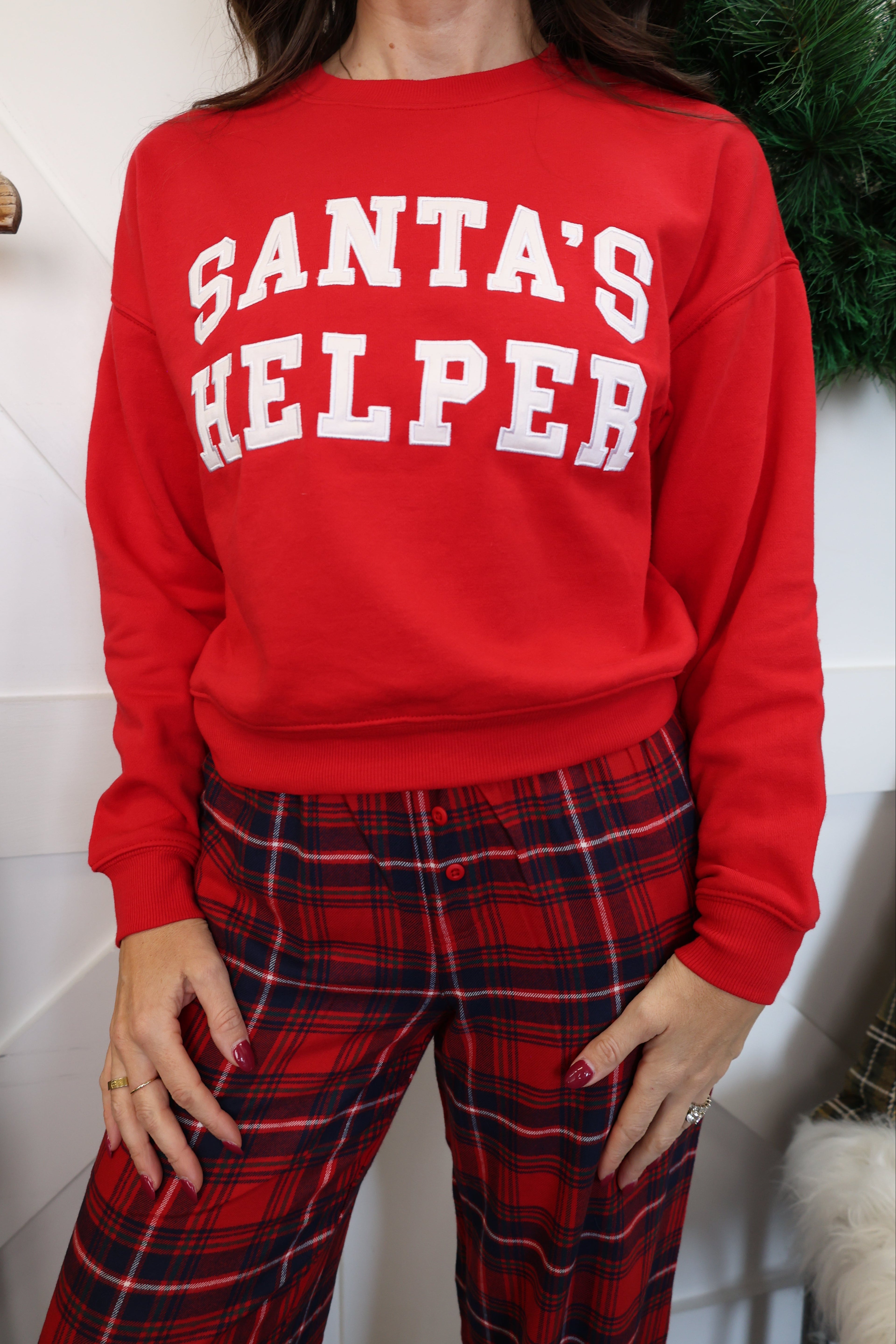 Z Supply long sleeve holiday sweatshirt in bright red with white Santa’s Helper graphic.