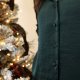 Close-up of Z Supply green satin button-down shirt showcasing smooth sheen and collared neckline.