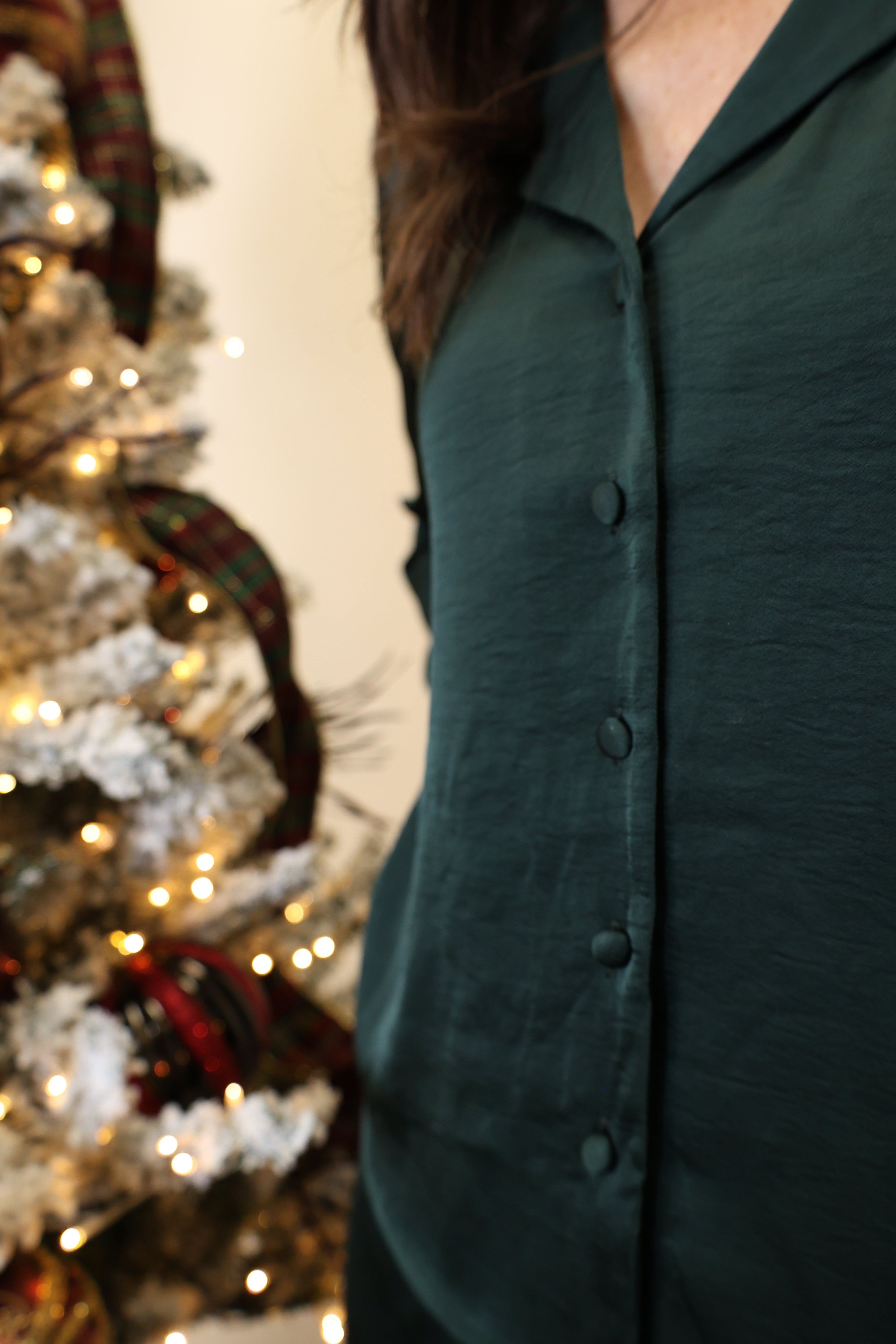 Close-up of Z Supply green satin button-down shirt showcasing smooth sheen and collared neckline.