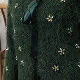 Green fuzzy cardigan from Another Love featuring soft floral design and front tie closure.