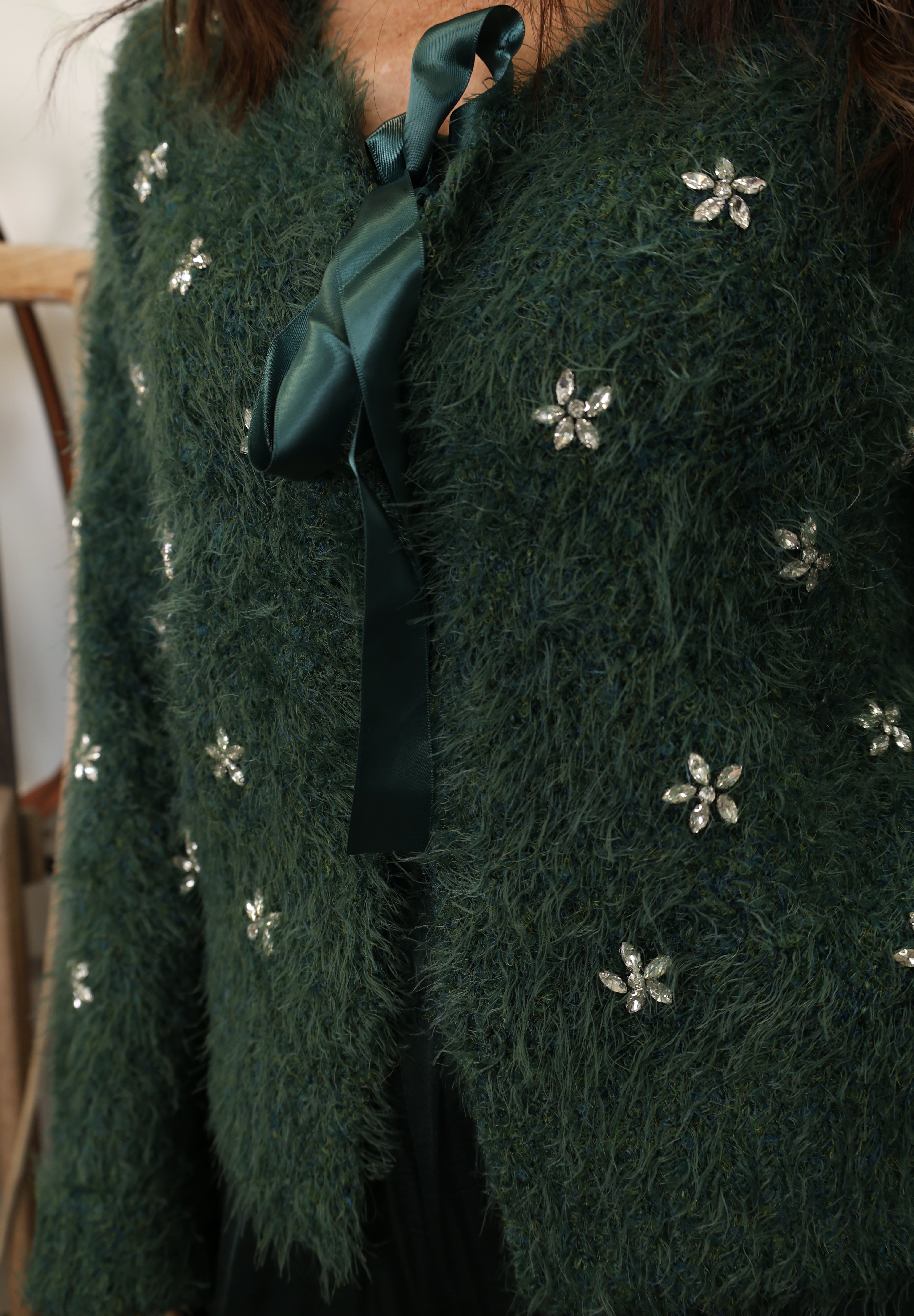 Green fuzzy cardigan from Another Love featuring soft floral design and front tie closure.