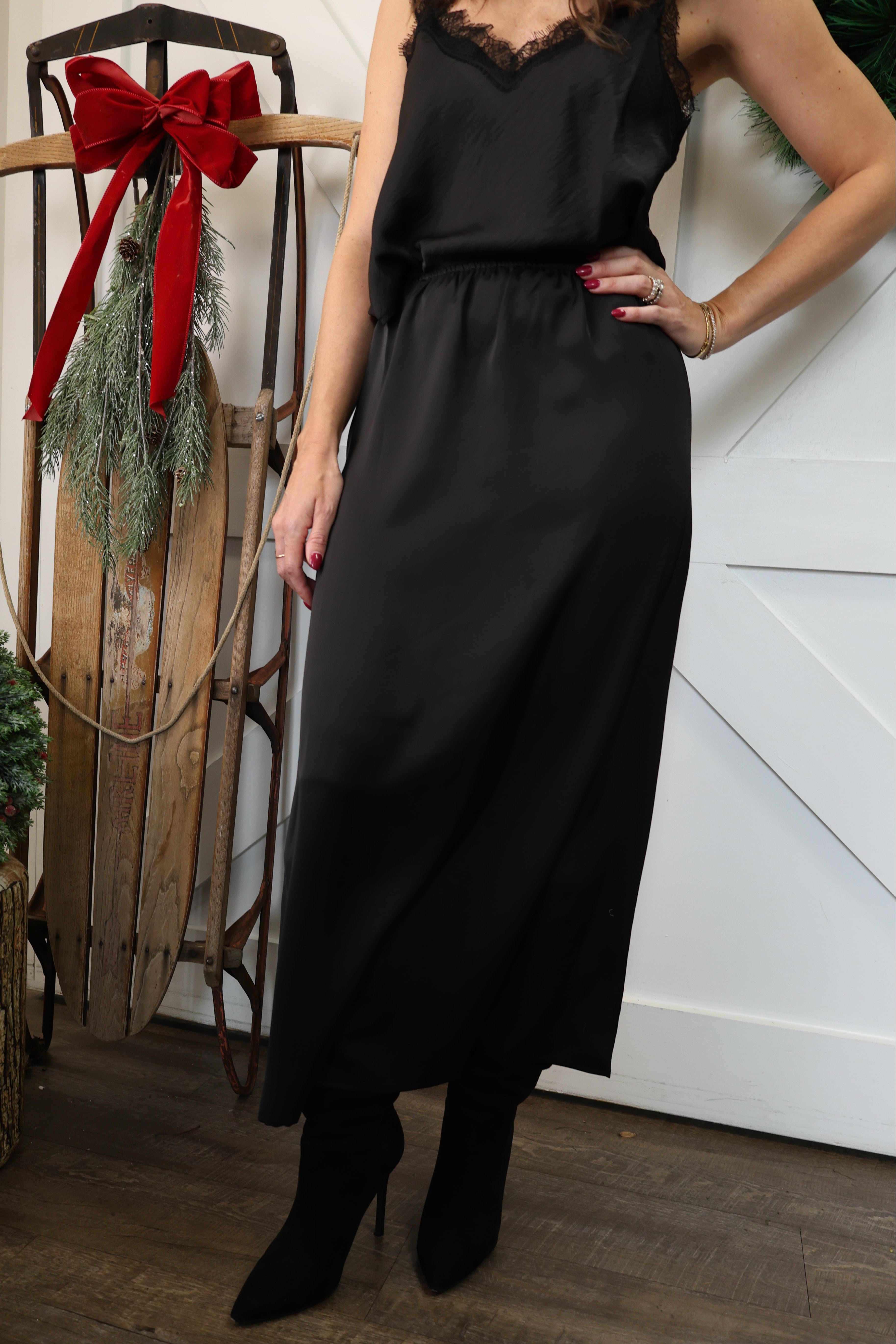 Front view of Another Love black satin maxi skirt with high-rise elastic waistband.