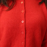Close-up of Z Supply Medina Sweater showing red knit fabric, crew neckline, and front button details.