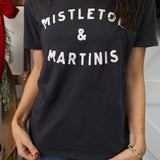 Model wearing Z Supply Mistletoe Boyfriend Tee in black with ‘Mistletoe and Martinis’ front graphic.