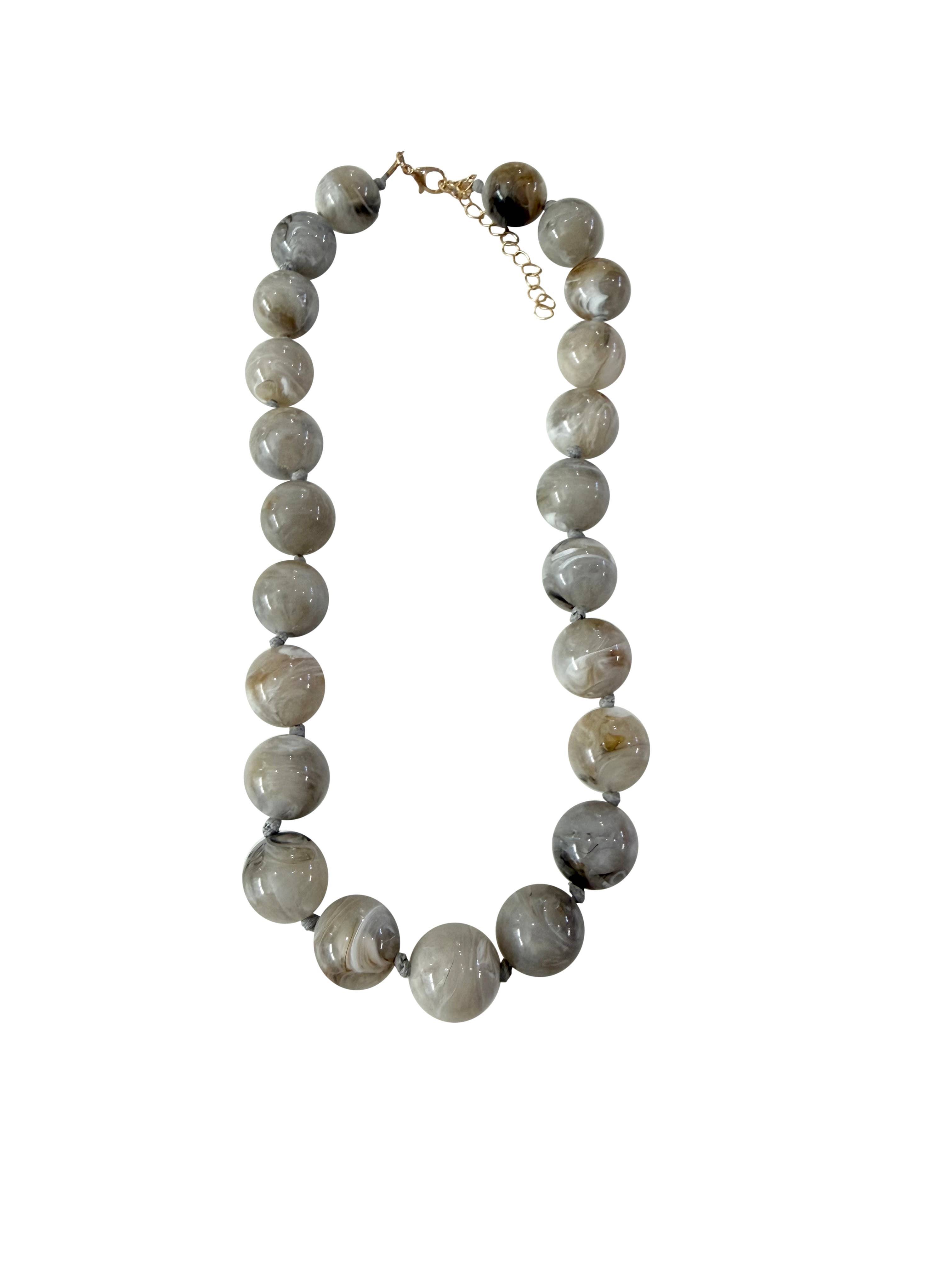 Gemelli Mabry chunky grey beaded necklace featuring large marbled stone beads and gold accent clasp.