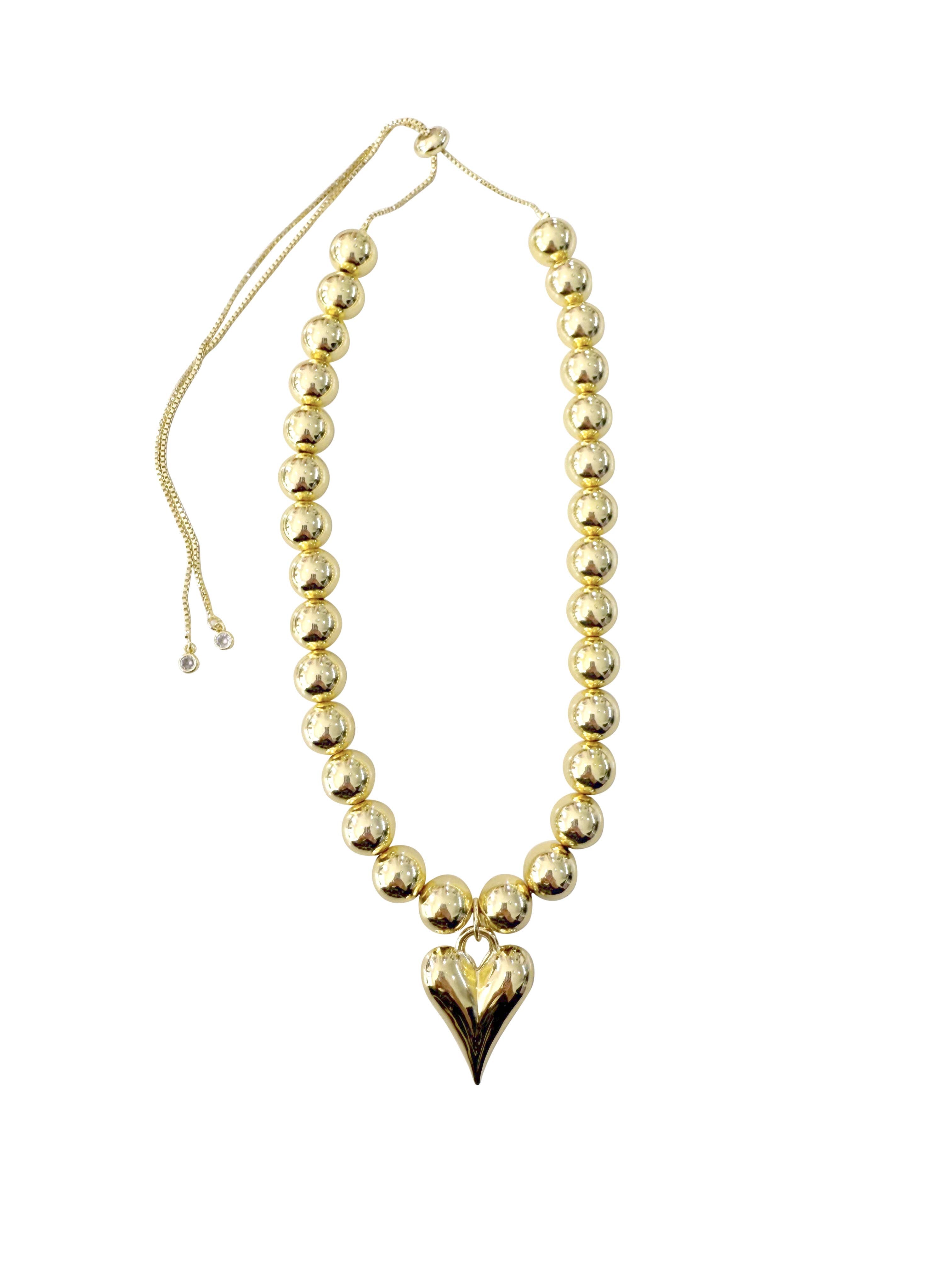 Gemelli Gianna Gold Happy Heart Necklace featuring a small gold heart charm on an adjustable, beaded gold chain.